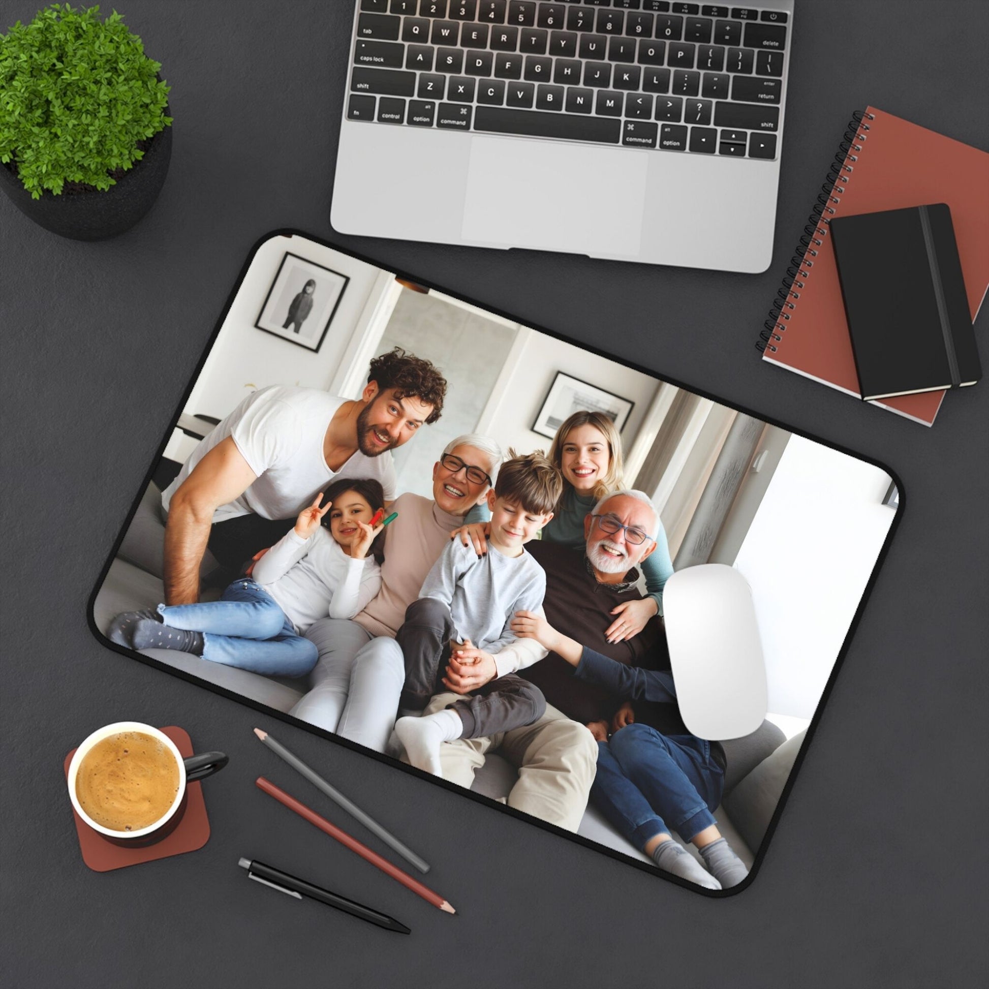 Desk pad 12x18 Family photo on a mouse pad with a laptop, coffee, and stationery on a desk.