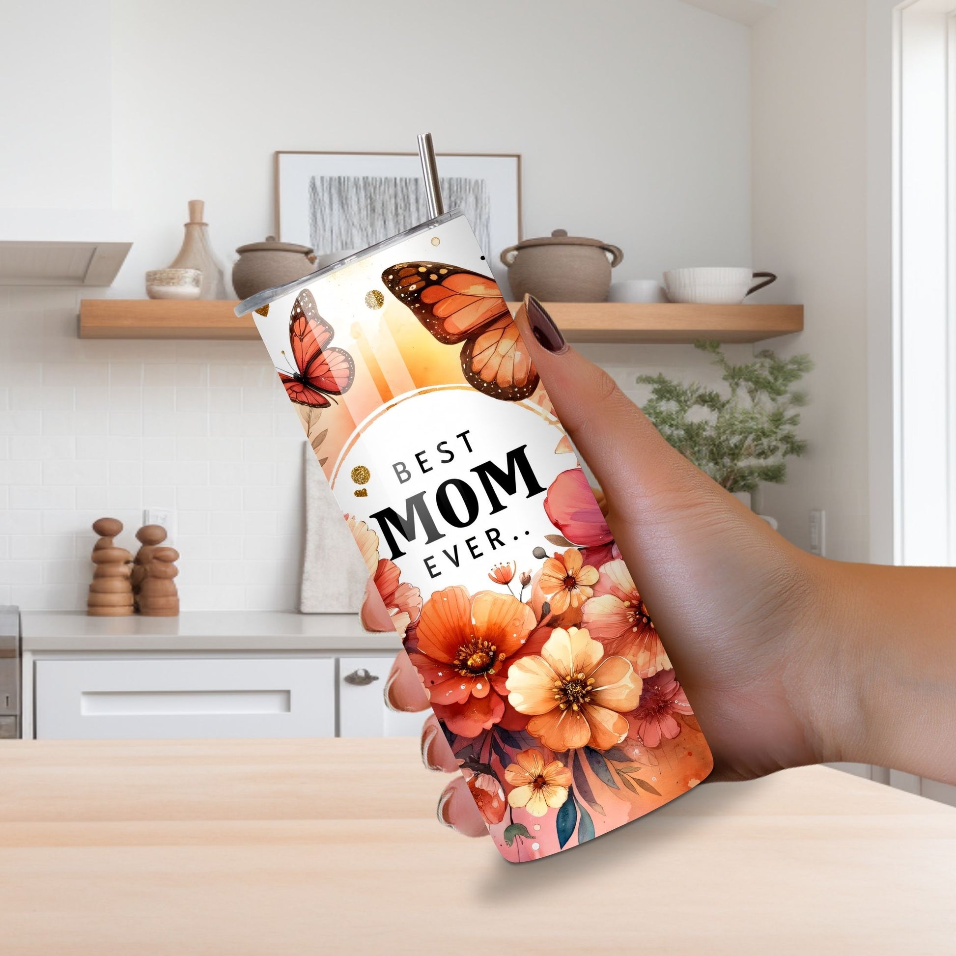 Lilmonal best mom ever tumbler with floral and butterfly design held in hand