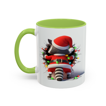 Lilmonal holiday raccoon coffee cup with green handle and rim featuring raccoon in Santa outfit