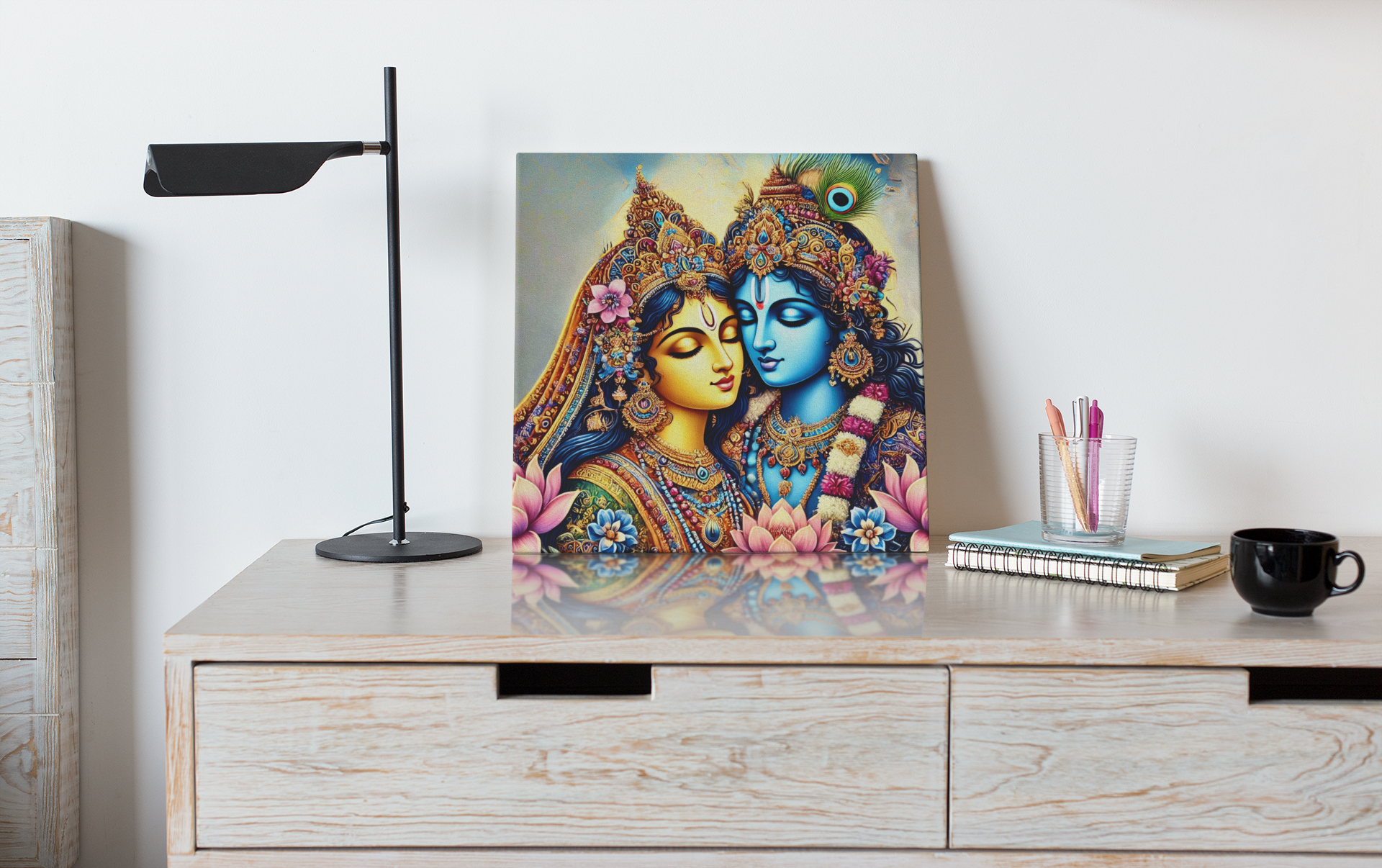 Radha Krishna canvas wall art depicting colorful traditional Indian artwork displayed on wooden desk