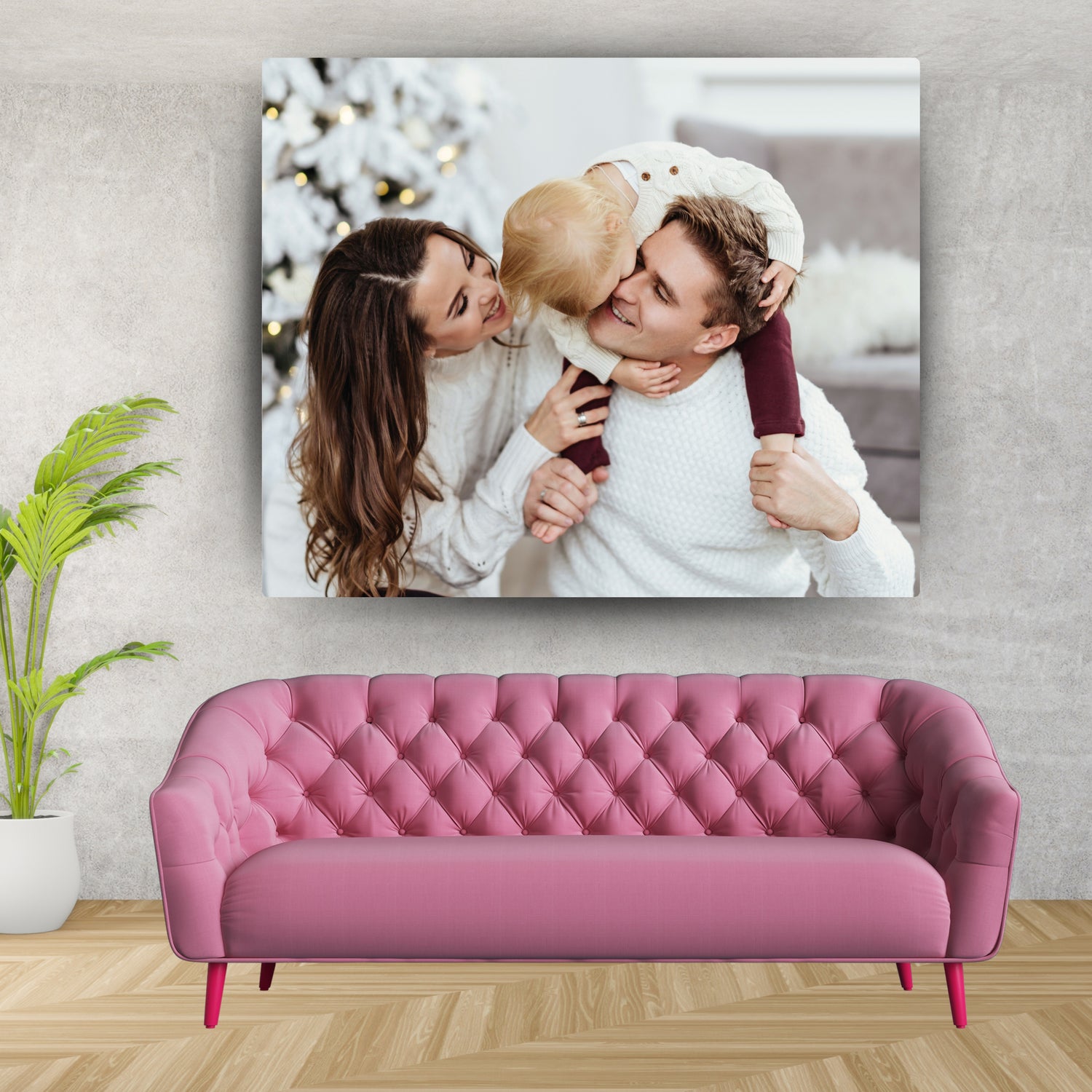 Canvas wall art by lilmonal featuring a happy family photo above a pink tufted sofa in a modern living room