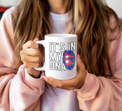 I love Nepal coffee mug with Nepal flag fingerprint design held by person wearing pink sweatshirt